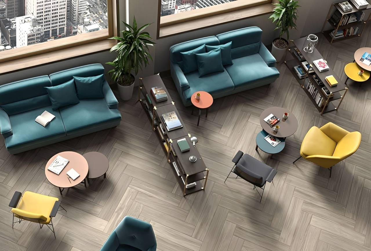 Stylish Office Lounge Featuring Teal and Yellow Seating, Coffee Tables, and Bookshelves, Designed for Relaxation and Collaboration in a City High-Rise.