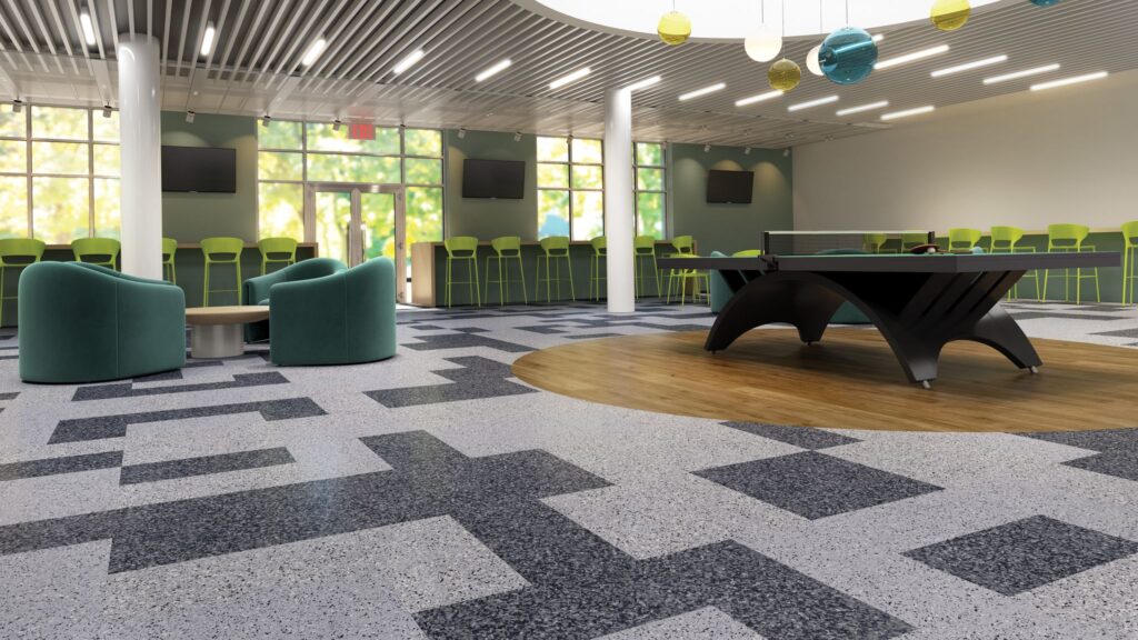 Bright, modern lounge area with green seating, a wooden table, and a ping pong table. Large windows provide natural light, enhancing the inviting atmosphere.