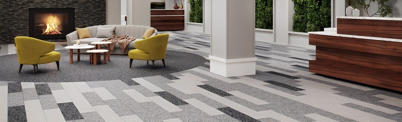 Modern Lounge Area Featuring a Cozy Seating Arrangement With Yellow Chairs, a Coffee Table, and a Fireplace, Showcasing Stylish Patterned Flooring.
